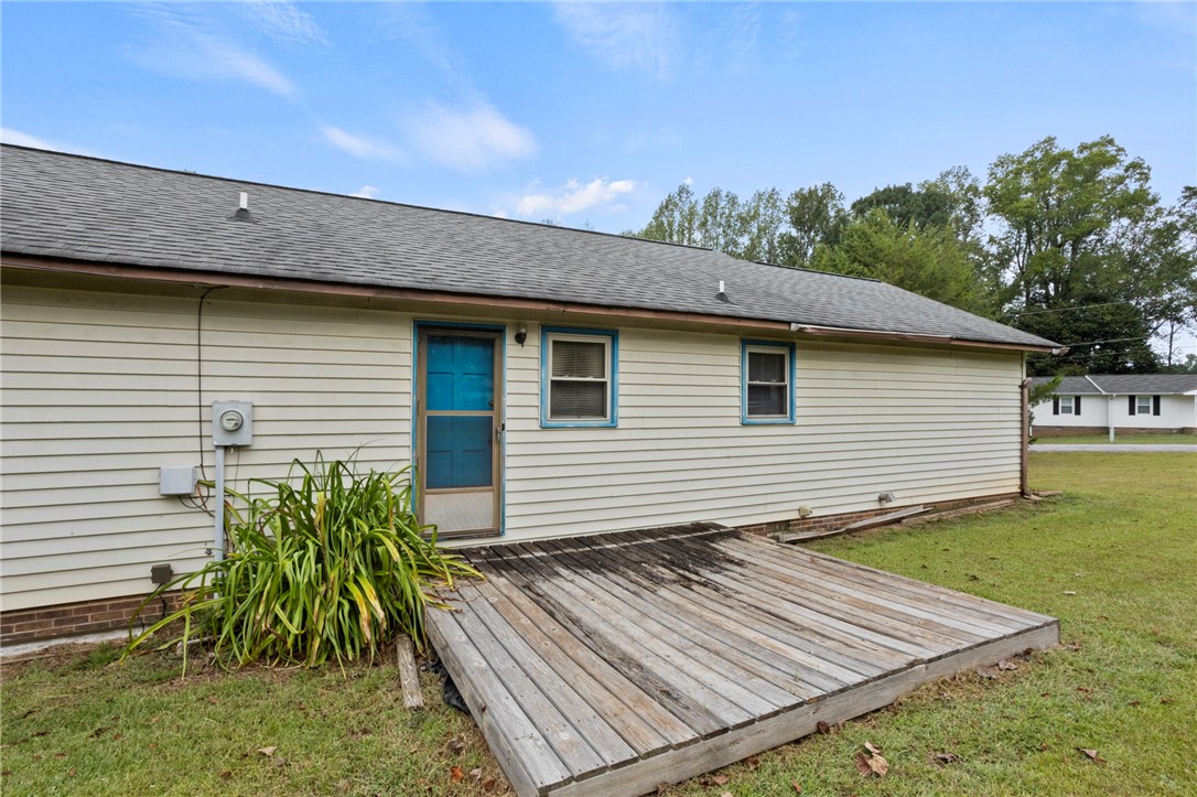 1022 Lakemont Road Starr, SC 29684 - Photo 23 of 24 A low wooden deck adjoins the siding exterior under a shingle roofline.