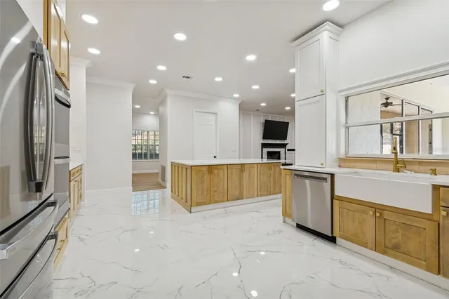 a view of kitchen with microwave a stove and a refrigerator