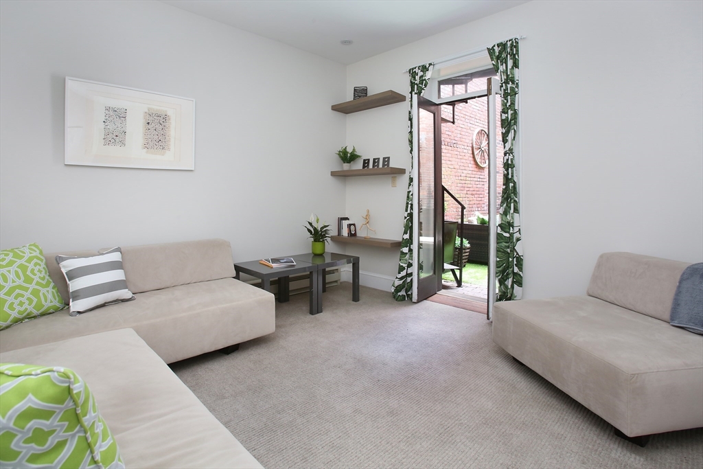 615 Massachusetts Avenue, Unit 2 Boston, MA 02118 - Photo 11 of 32 a living room with furniture and a painting on the wall