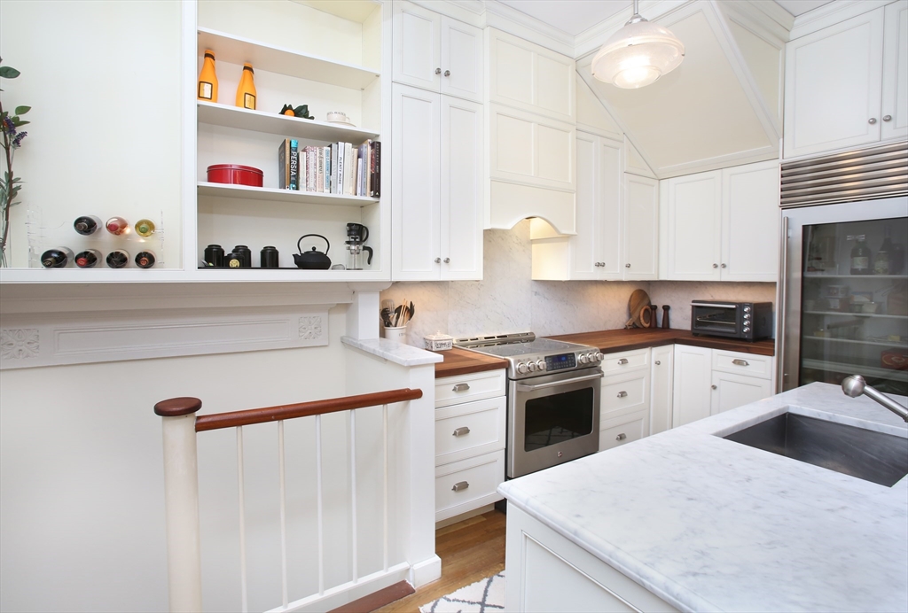 615 Massachusetts Avenue, Unit 2 Boston, MA 02118 - Photo 22 of 32 a kitchen with a white stove top oven and white cabinets
