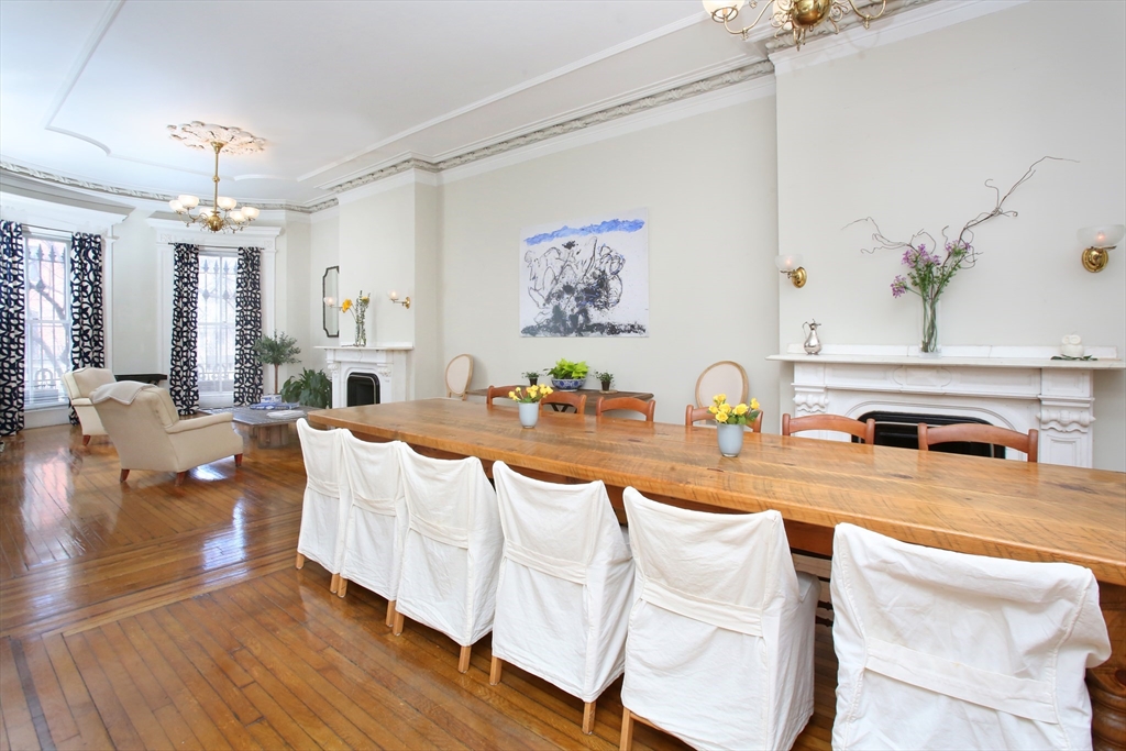 615 Massachusetts Avenue, Unit 2 Boston, MA 02118 - Photo 24 of 32 a living room with granite countertop furniture a fireplace and a chandelier