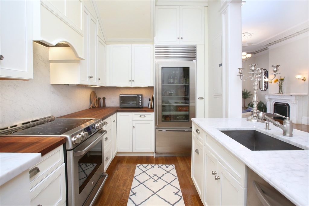 615 Massachusetts Avenue, Unit 2 Boston, MA 02118 - Photo 4 of 32 a kitchen with a sink stove top oven and refrigerator