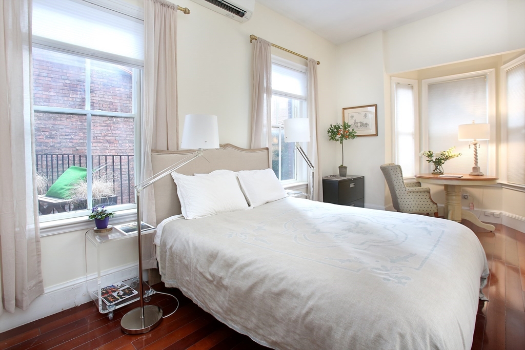 615 Massachusetts Avenue, Unit 2 Boston, MA 02118 - Photo 8 of 32 a bedroom with a bed and wooden floor