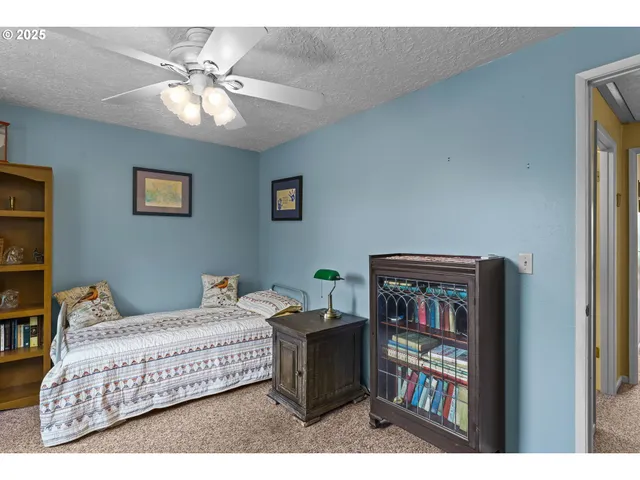 a bedroom with furniture and a book shelf