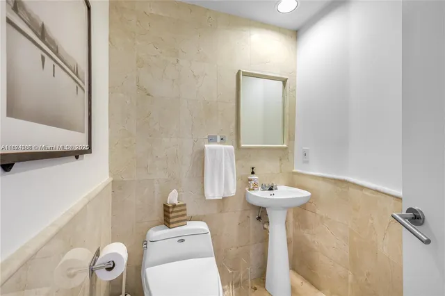 a bathroom with a sink mirror and toilet