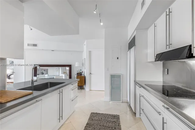 a kitchen with a sink stove and cabinets