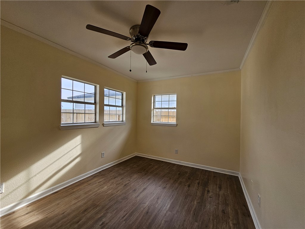 949 Stone Street Corpus Christi, TX 78418 - Photo 6 of 13 a view of an empty room with wooden floor and a window