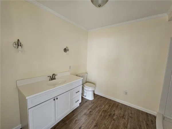 a bathroom with a toilet a sink and vanity