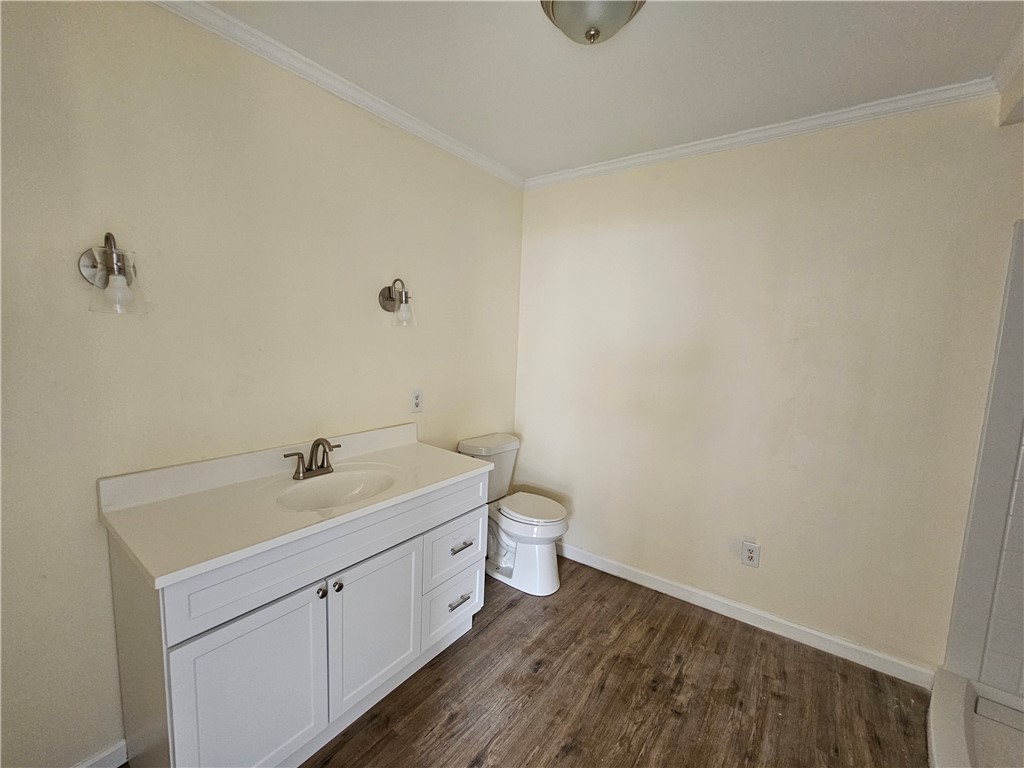949 Stone Street Corpus Christi, TX 78418 - Photo 8 of 13 a bathroom with a toilet a sink and vanity