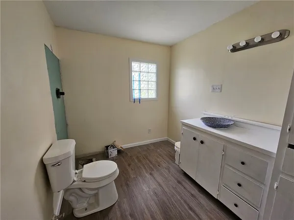 a bathroom with a sink mirror vanity and toilet