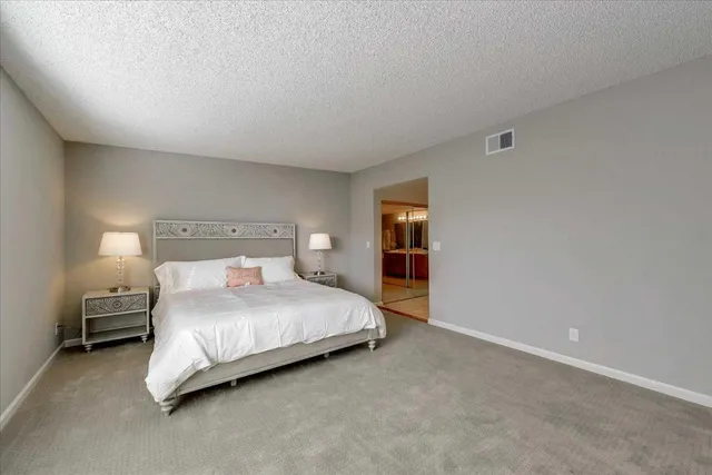 a bedroom with a bed and a lamp