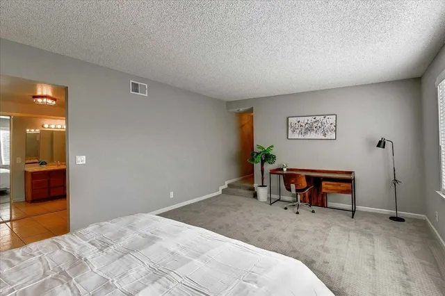 a bedroom with a bed and a chair