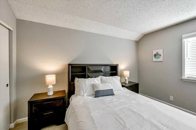 a bedroom with a bed and a lamp