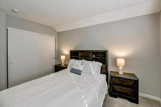 a bedroom with a bed and a lamp