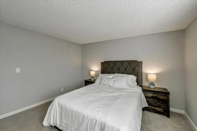 a bedroom with a bed and a lamp