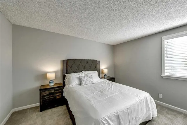 a bedroom with a bed and a night stand