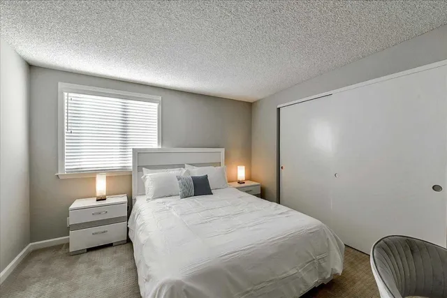 a bedroom with a bed and a chair