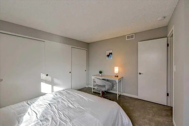 a bedroom with a bed and a cabinets