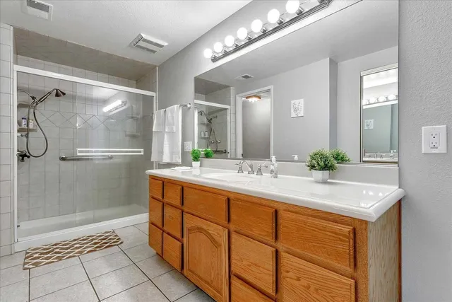 a bathroom with a shower sink and mirror
