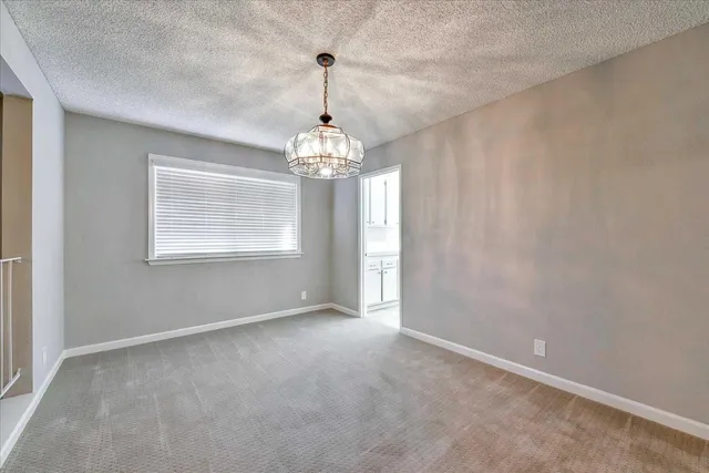 a view of an empty room with windows