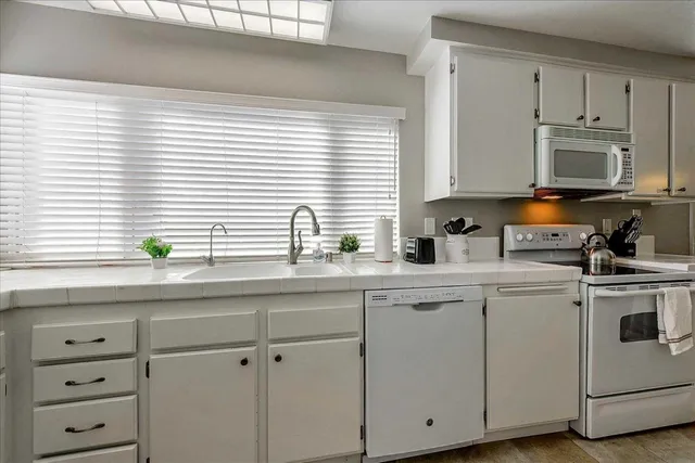 a kitchen with appliances cabinets and a window