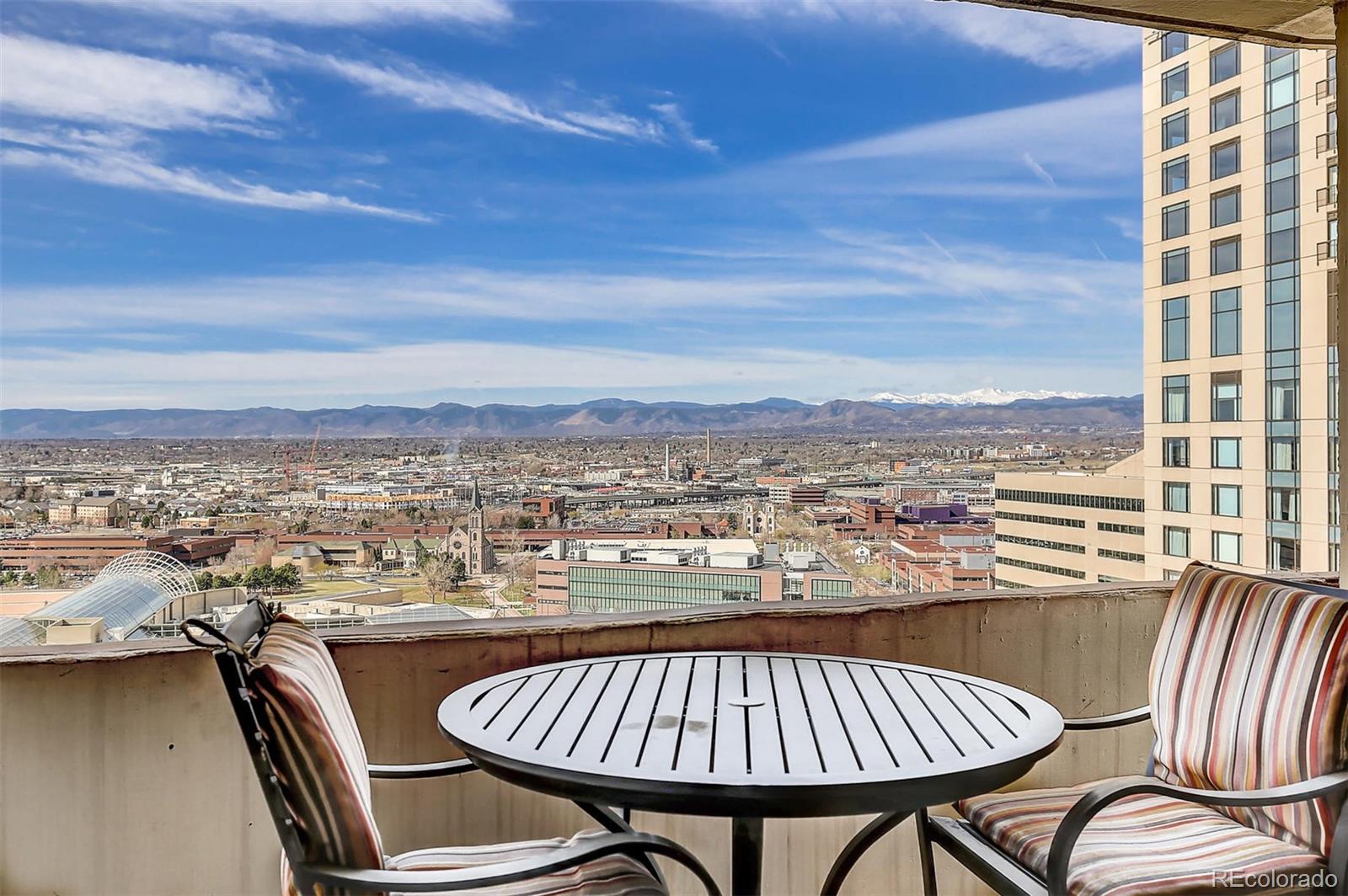 a view of a balcony with a table and chair