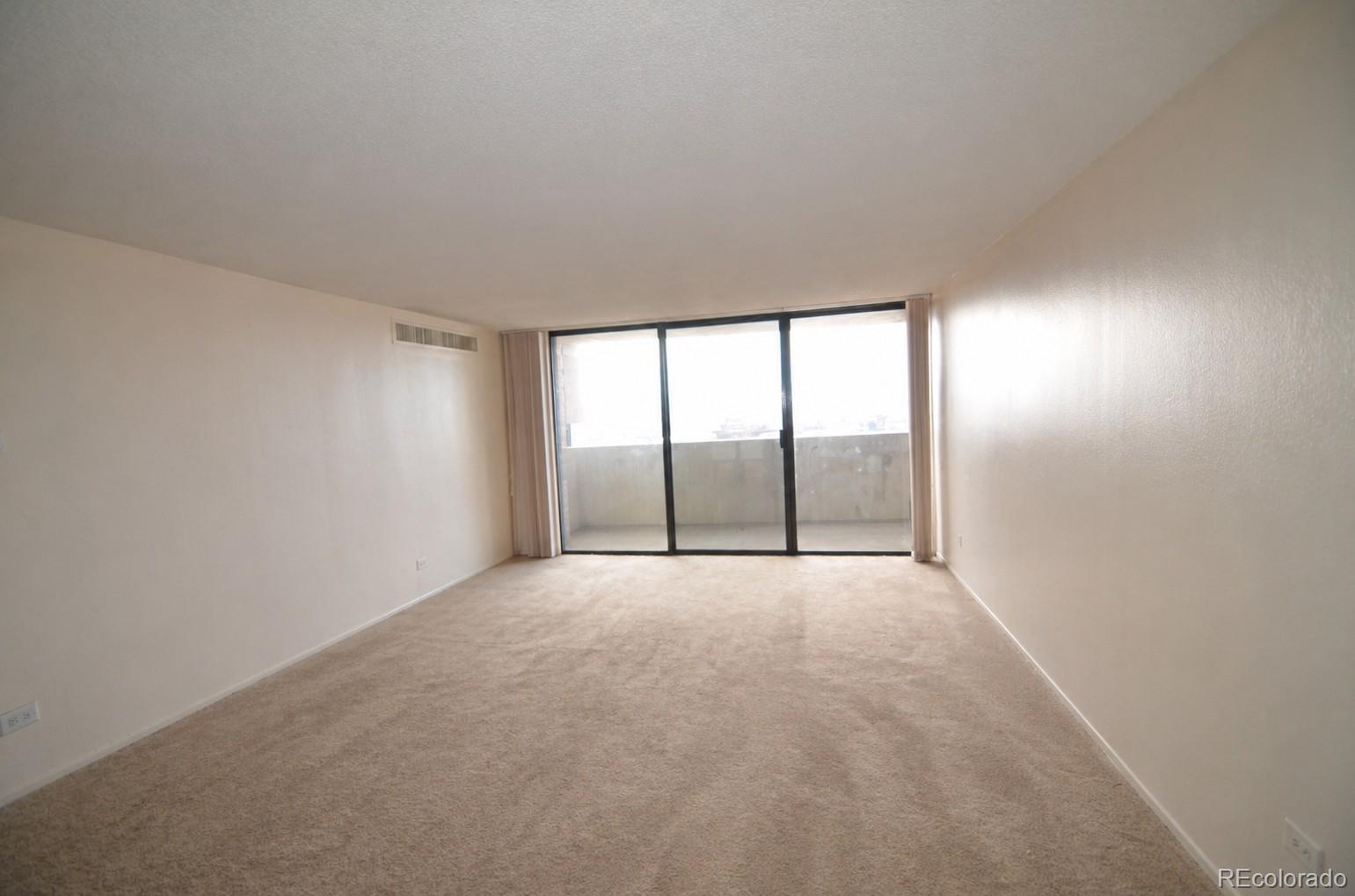 1020 15th Street, Unit 25B Denver, CO 80202 - Photo 2 of 33 wooden floor in an empty room with a window