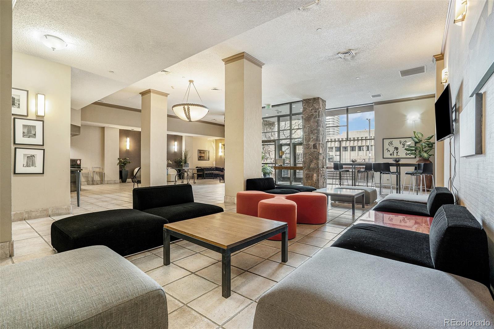 1020 15th Street, Unit 25B Denver, CO 80202 - Photo 30 of 33 a living room with furniture and a floor to ceiling window