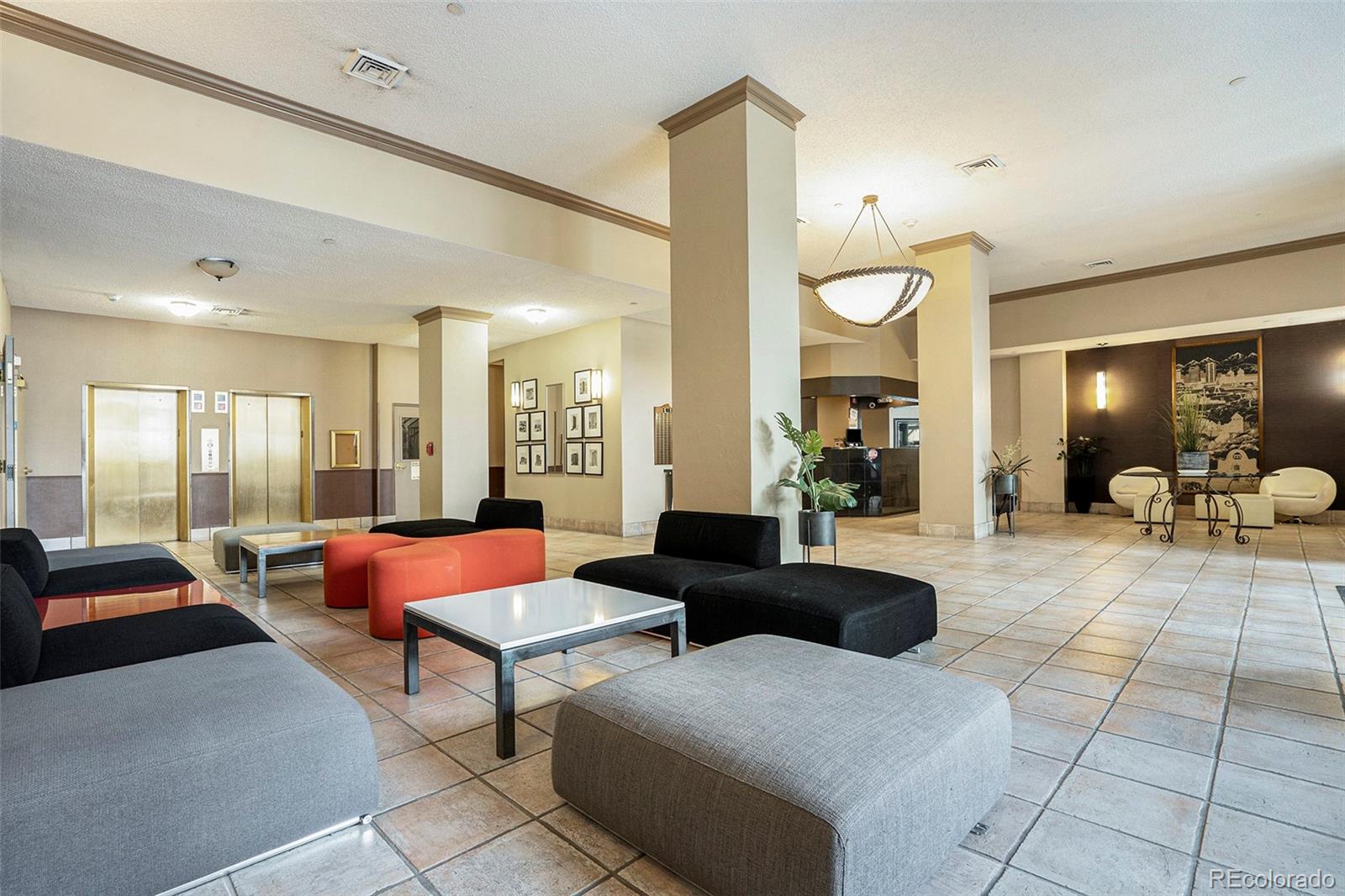 1020 15th Street, Unit 25B Denver, CO 80202 - Photo 31 of 33 a living room with furniture a rug and a chandelier