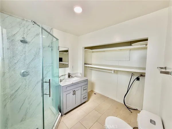 a bathroom with a granite countertop shower a sink and a mirror
