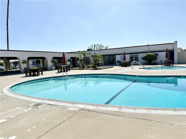 a view of a house with swimming pool and sitting area
