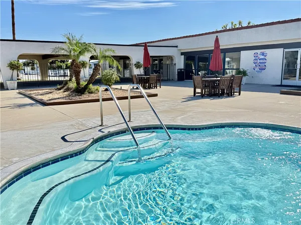 a room with lots of flower plants and couches chair