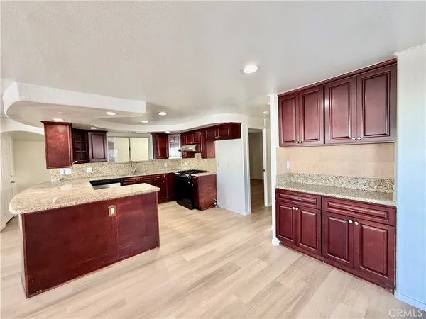 a large kitchen with stainless steel appliances granite countertop a large counter top and oven