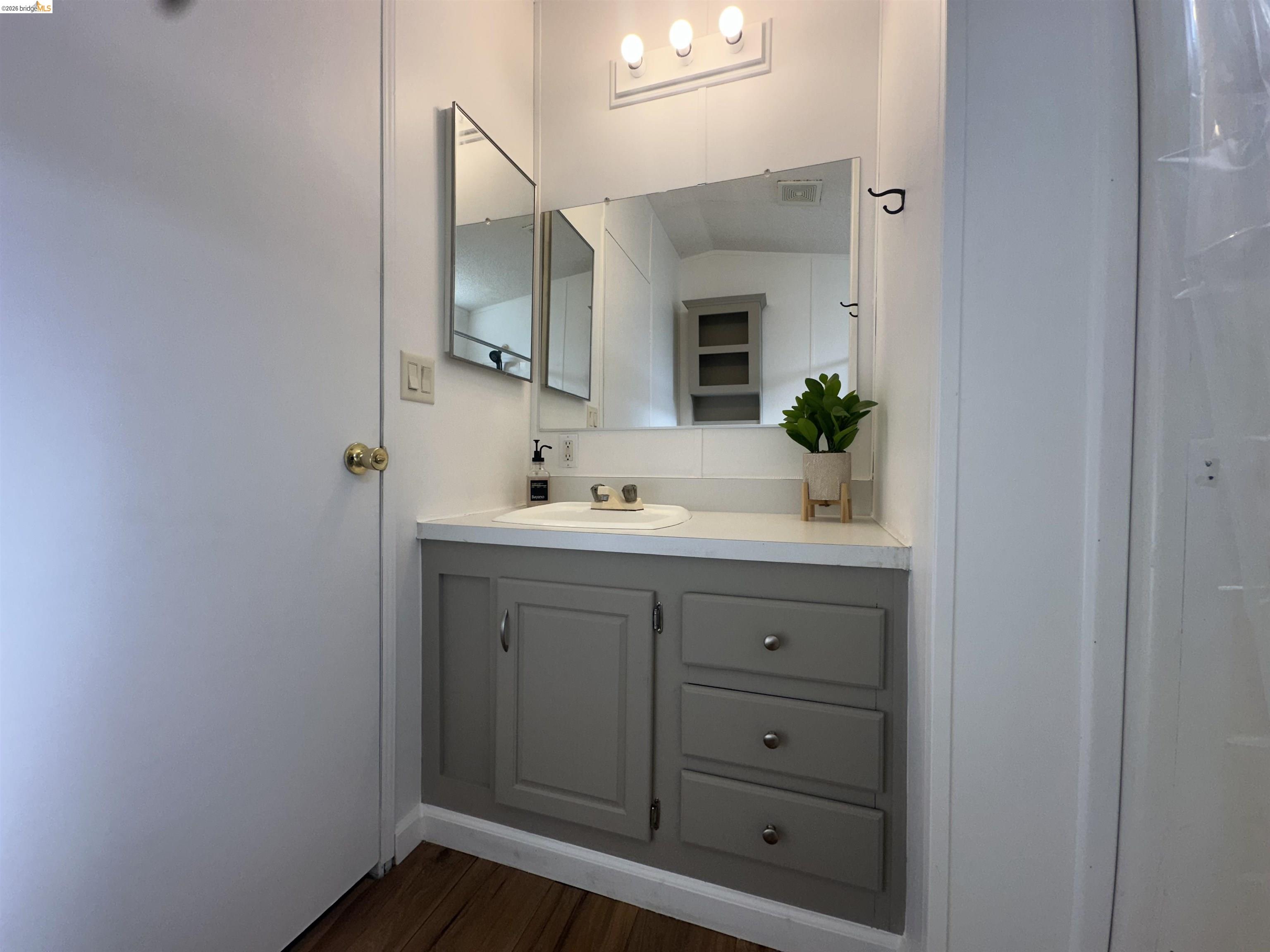 14192 Tuolumne Road, Unit 5 Sonora, CA 95370 - Photo 7 of 12 Bathroom with vanity and dark wood-style floors