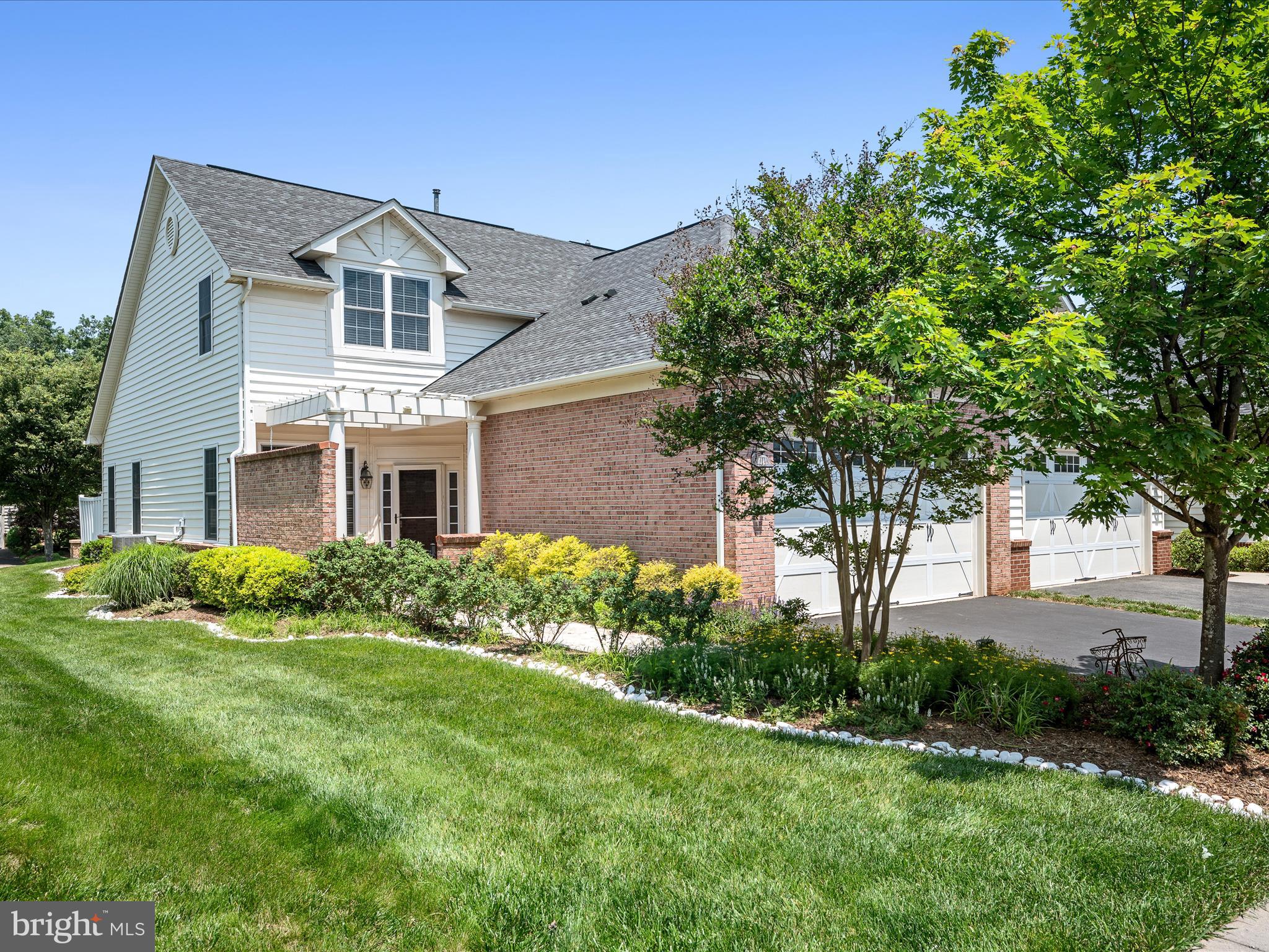 44322 Stableford Square Ashburn, VA 20147 - Photo 3 of 63 a front view of a house with a yard