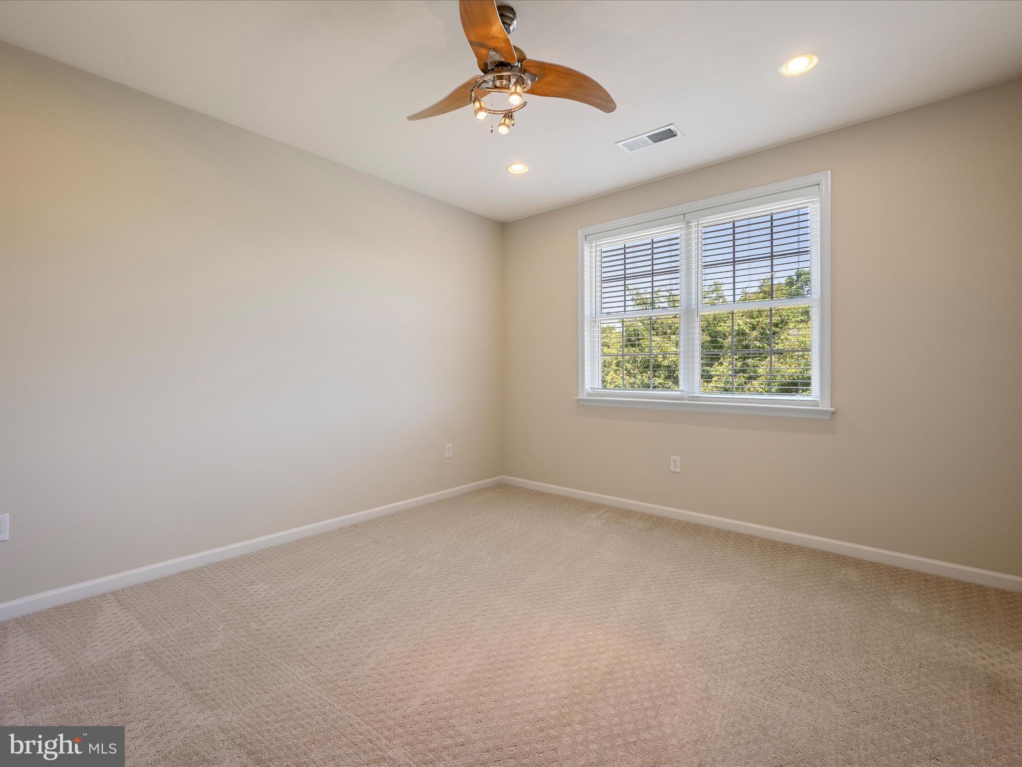 44322 Stableford Square Ashburn, VA 20147 - Photo 36 of 63 an empty room with a window and a ceiling fan