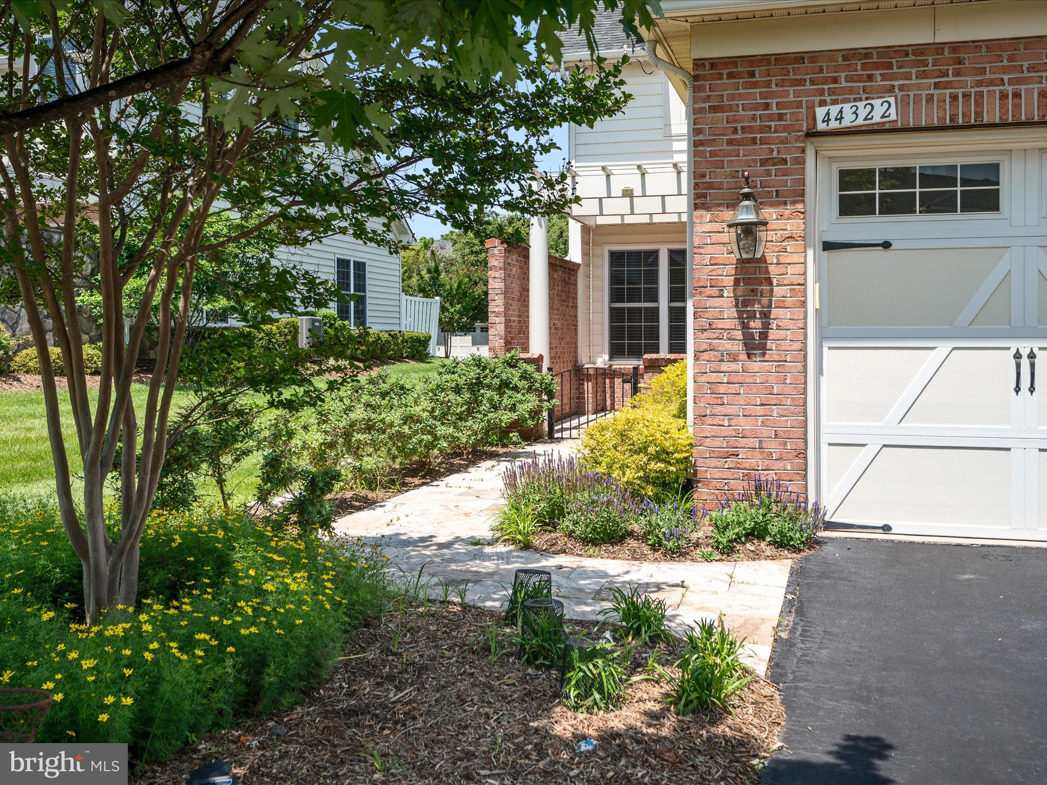 44322 Stableford Square Ashburn, VA 20147 - Photo 5 of 63 a front view of a house with garden