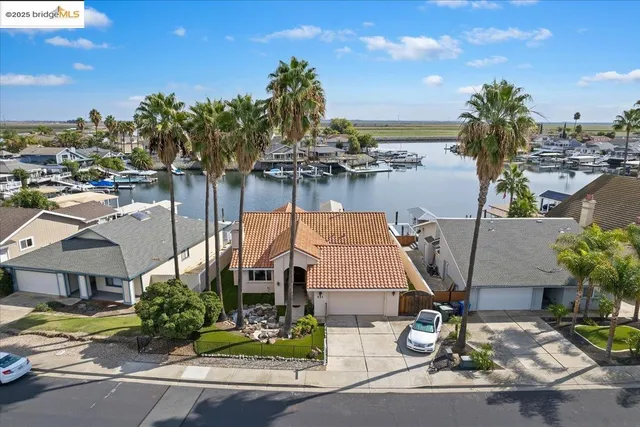 a aerial view of a house with garden space and lake view