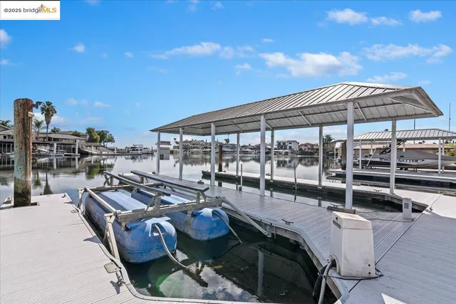 a view of a patio with a dining table and chairs under an umbrella