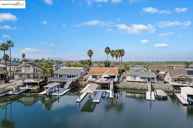 a view of a house with pool and chairs
