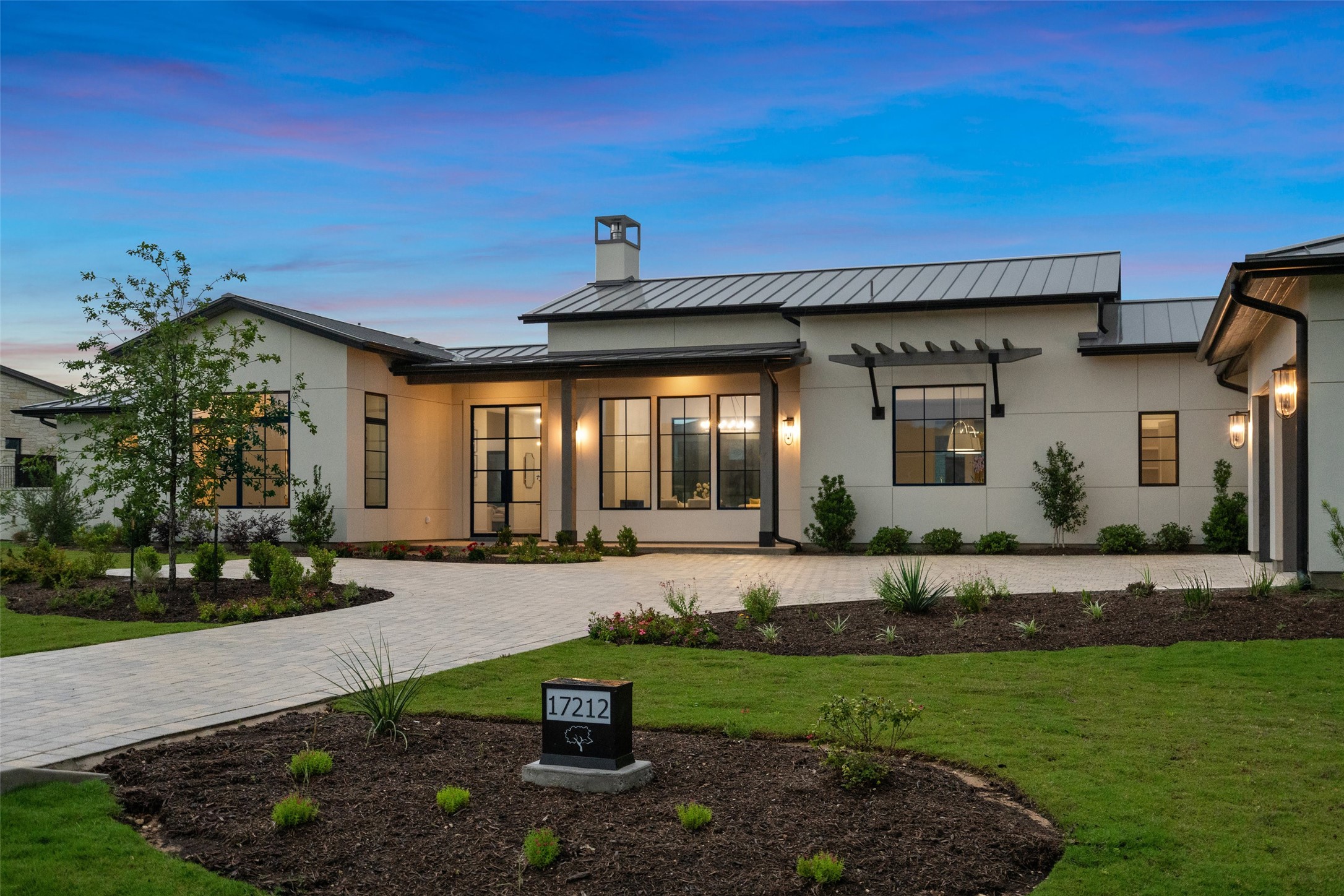 17212 Morning Grove Lane Austin, TX 78738 - Photo 1 of 38 a front view of a house with garden