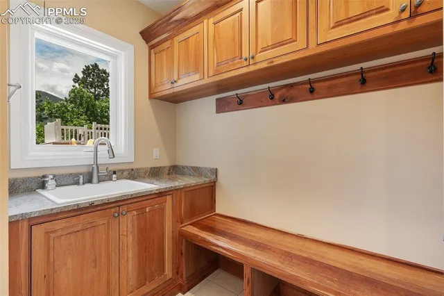 a bathroom with a granite countertop toilet sink and mirror