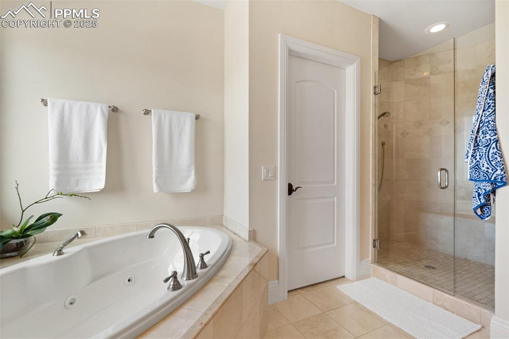 4490 Star Ranch Road Colorado Springs, CO 80906 - Photo 24 of 50 a bathroom with a bathtub and a shower