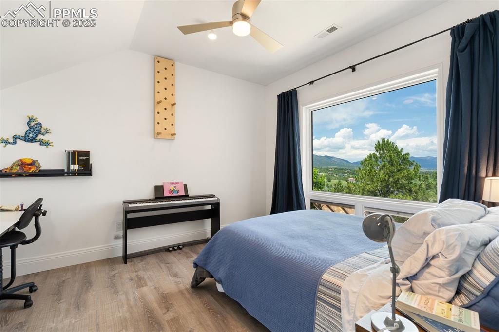 4490 Star Ranch Road Colorado Springs, CO 80906 - Photo 29 of 50 a bedroom with a bed and a large window
