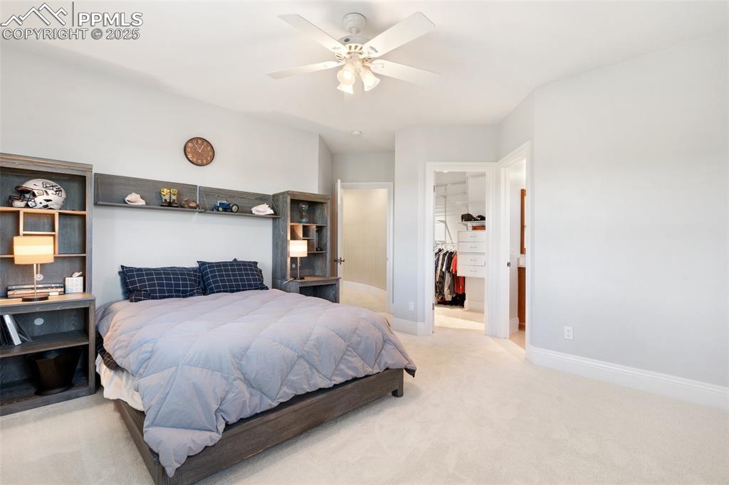 4490 Star Ranch Road Colorado Springs, CO 80906 - Photo 32 of 50 a bedroom with a bed and a chandelier