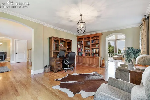 a view of a livingroom with workspace and a window