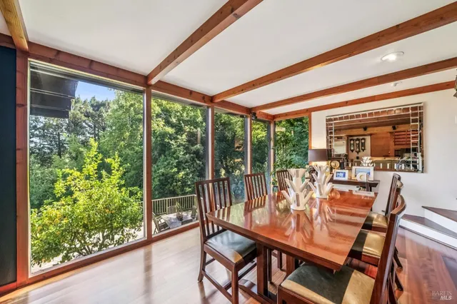 a dining room with furniture window and outside view