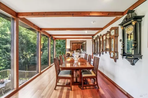 a dining room with furniture water view and wooden floor