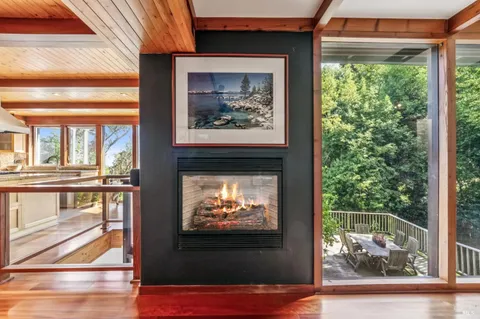 a living room with a fireplace and a flat screen tv