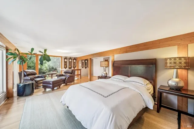 a spacious bedroom with a bed and large windows